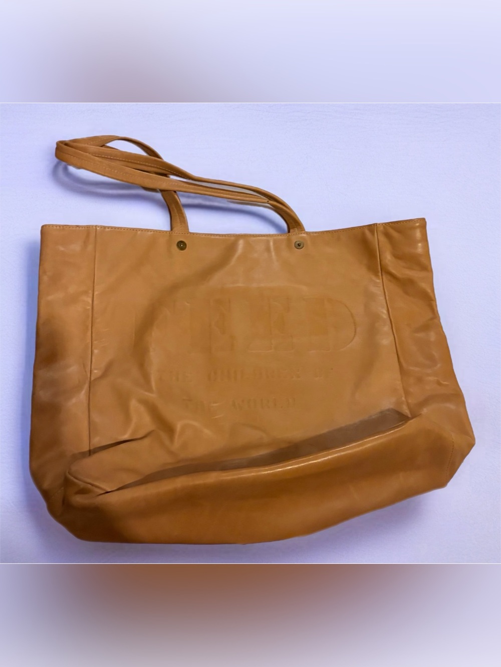 Feed Projects Tan Leather Tote Bag with “Feed the Children of the World” written